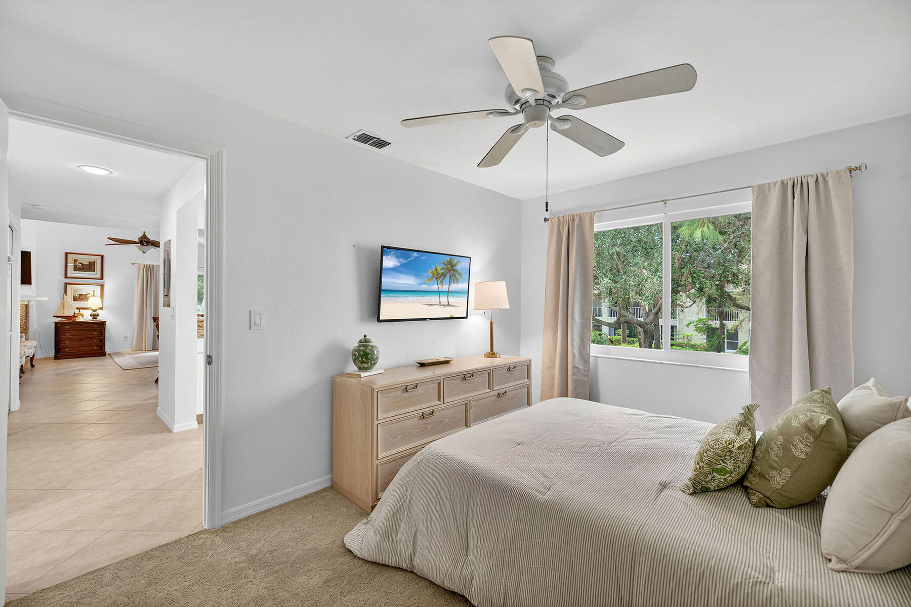 3136 Kings Lake Boulevard, Unit 7546 Naples, FL 34112 - Photo 19 of 32 a bedroom with a large bed and a window