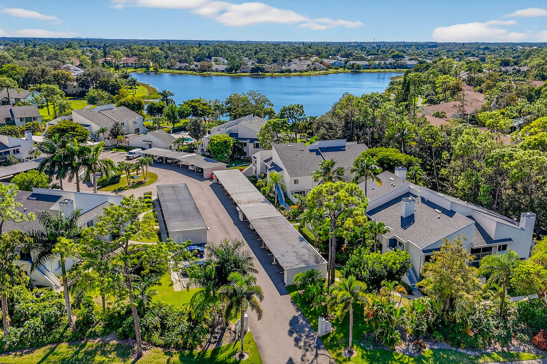 3136 Kings Lake Boulevard, Unit 7546 Naples, FL 34112 - Photo 26 of 32 an aerial view of house with yard and lake view