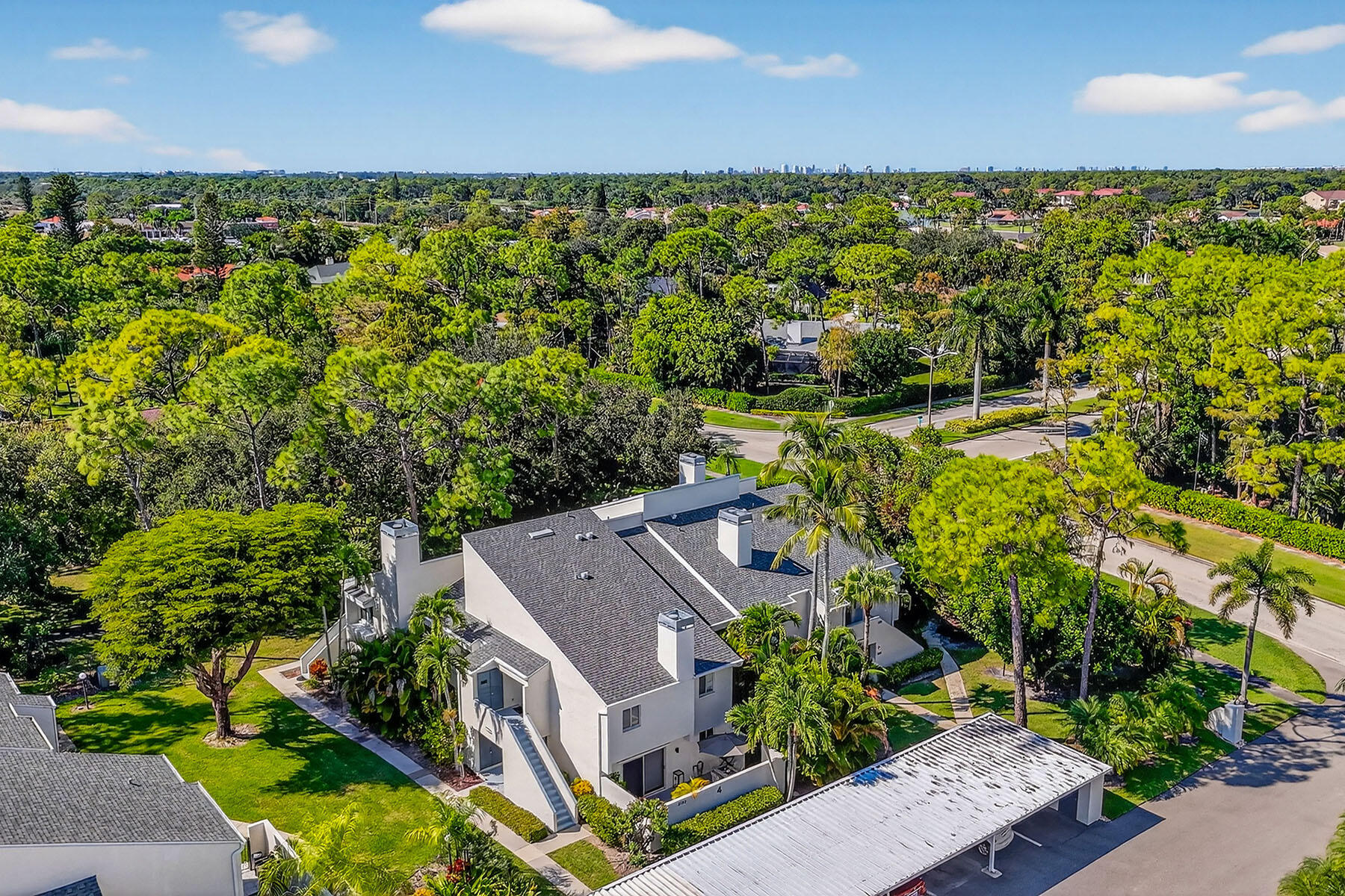 3136 Kings Lake Boulevard, Unit 7546 Naples, FL 34112 - Photo 31 of 32 an aerial view of a house with a garden and lake view