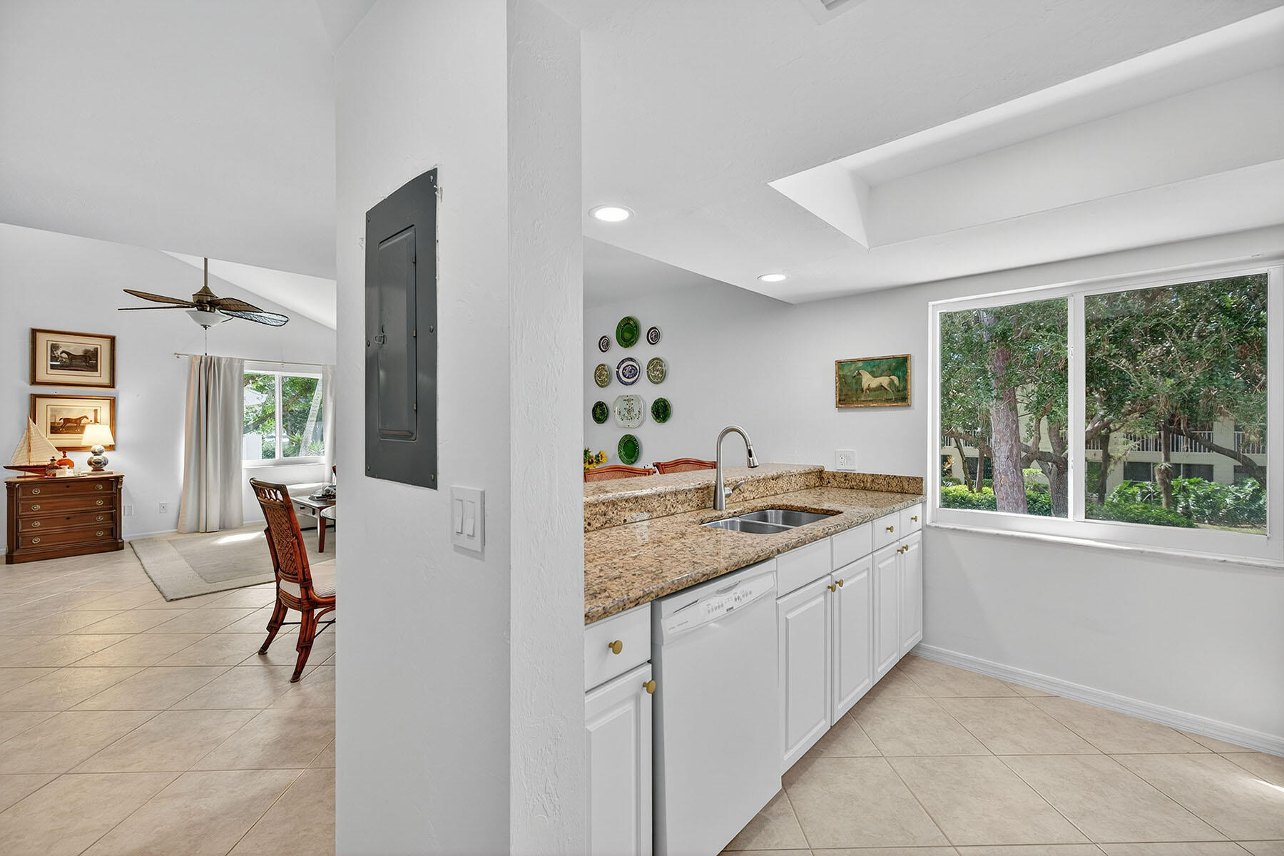 3136 Kings Lake Boulevard, Unit 7546 Naples, FL 34112 - Photo 5 of 32 a living room with furniture and a large window