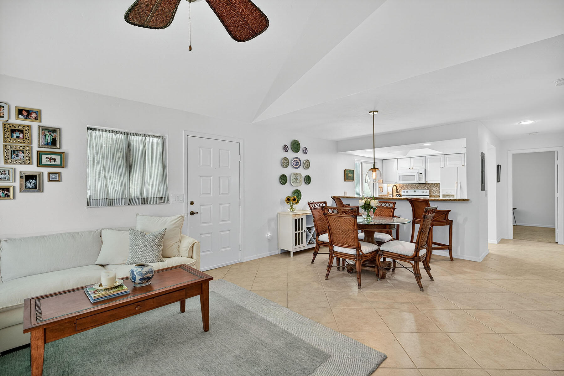 3136 Kings Lake Boulevard, Unit 7546 Naples, FL 34112 - Photo 10 of 32 a living room with furniture kitchen view and a window