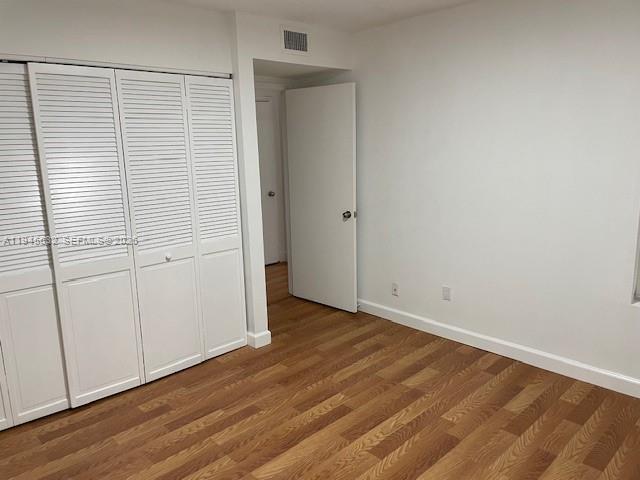 15325 Southwest 106th Terrace, Unit 618 Miami, FL 33196 - Photo 18 of 27 an empty room with wooden floor