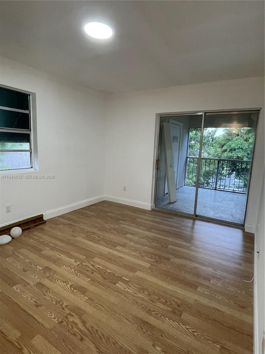 15325 Southwest 106th Terrace, Unit 618 Miami, FL 33196 - Photo 19 of 27 a view of empty room with wooden floor and fan