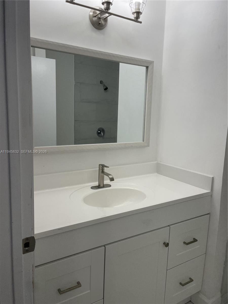 15325 Southwest 106th Terrace, Unit 618 Miami, FL 33196 - Photo 21 of 27 a bathroom with a sink and a mirror
