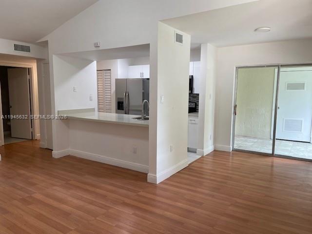 15325 Southwest 106th Terrace, Unit 618 Miami, FL 33196 - Photo 3 of 27 an empty room with wooden floor and windows