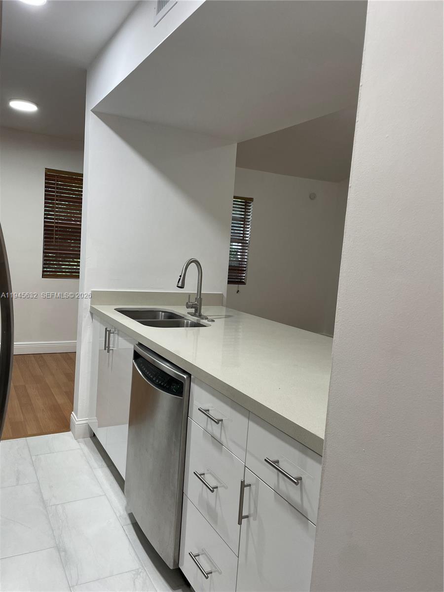 15325 Southwest 106th Terrace, Unit 618 Miami, FL 33196 - Photo 10 of 27 a utility room with sink dryer and washer