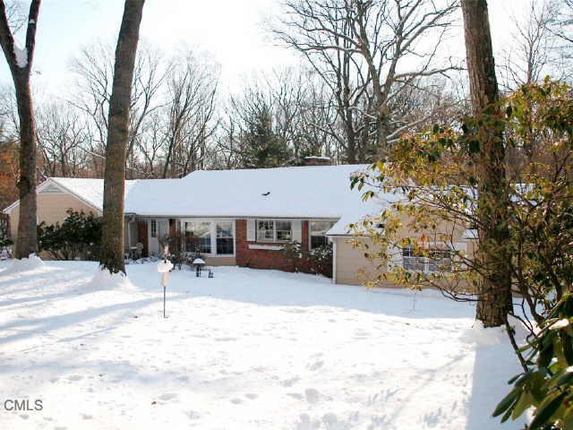 173 Sawmill Road Stamford, CT 06903 - Photo 1 of 1 a backyard of a house with table and chairs under an umbrella