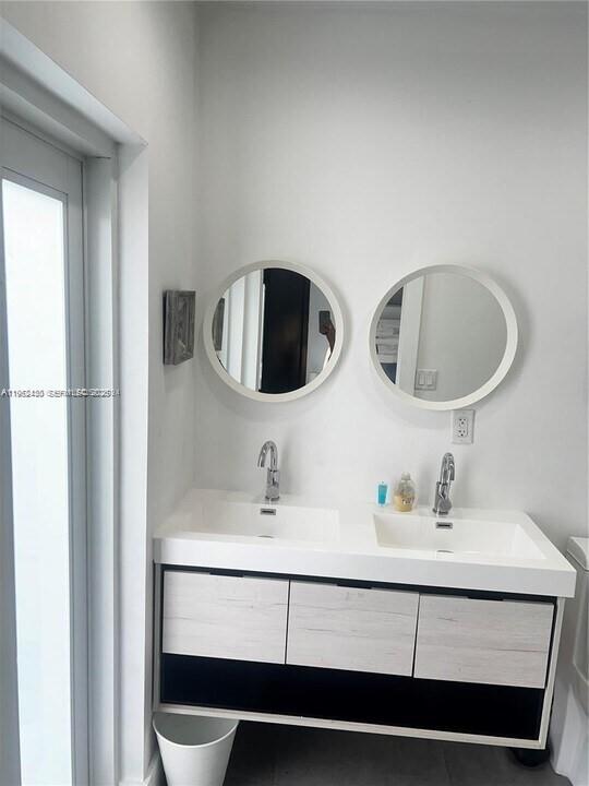 15 Northwest 52nd Street Miami, FL 33127 - Photo 17 of 28 a bathroom with a sink and a mirror