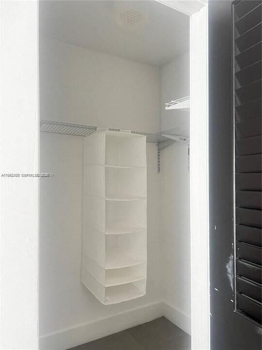 15 Northwest 52nd Street Miami, FL 33127 - Photo 19 of 28 a view of walk in closet with empty racks