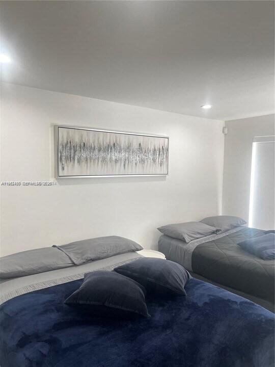 15 Northwest 52nd Street Miami, FL 33127 - Photo 24 of 28 a bedroom with bed and window