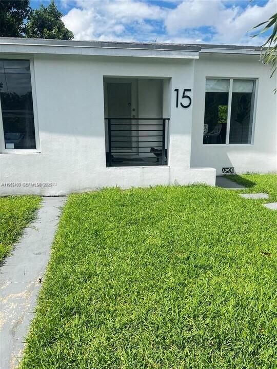 15 Northwest 52nd Street Miami, FL 33127 - Photo 3 of 28 a front view of a house with a garage