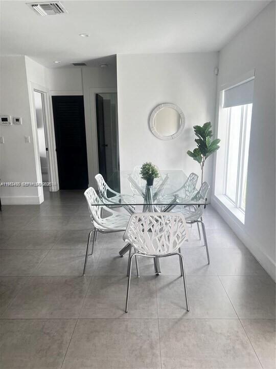 15 Northwest 52nd Street Miami, FL 33127 - Photo 7 of 28 a dining room with furniture and window