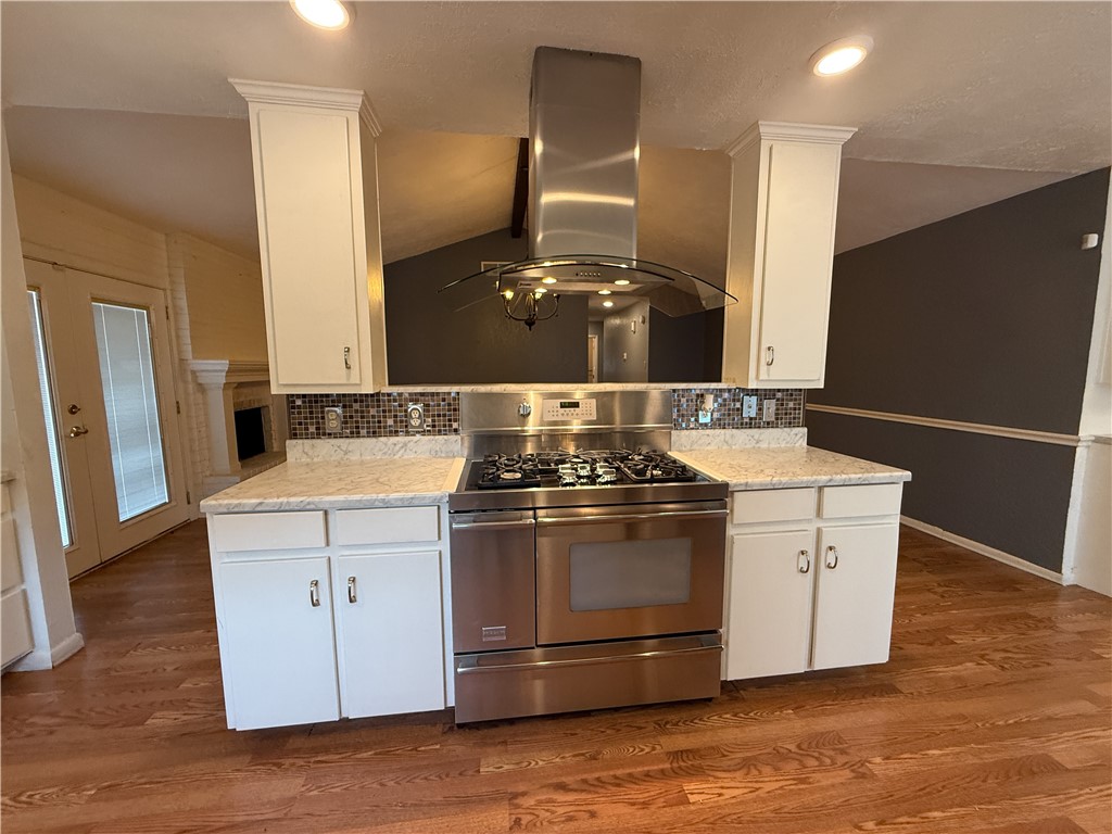 10502 Hemlock Road Corpus Christi, TX 78410 - Photo 12 of 31 a kitchen with a stove and a microwave