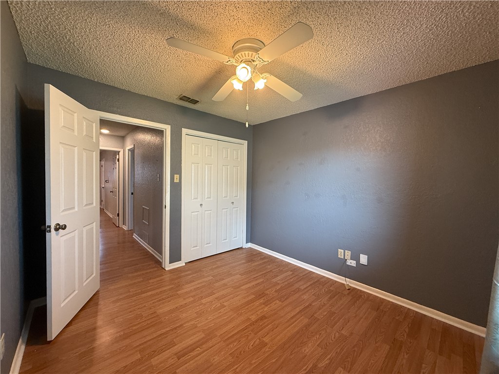 10502 Hemlock Road Corpus Christi, TX 78410 - Photo 20 of 31 an empty room with wooden floor and chandelier fan