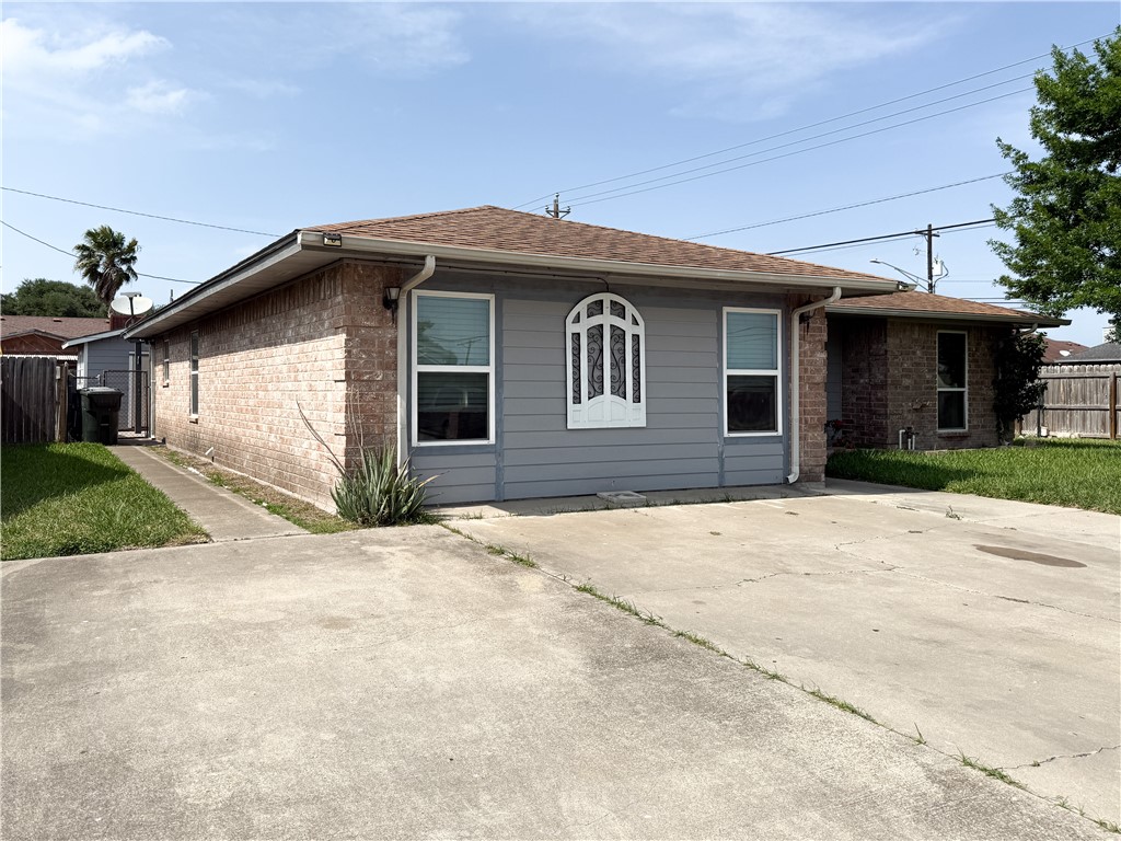 10502 Hemlock Road Corpus Christi, TX 78410 - Photo 2 of 31 a front view of a house with a yard and garage