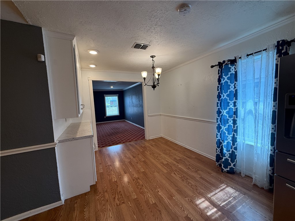 10502 Hemlock Road Corpus Christi, TX 78410 - Photo 4 of 31 wooden floor in an empty room with a window