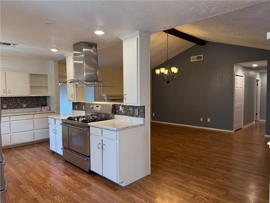 10502 Hemlock Road Corpus Christi, TX 78410 - Photo 6 of 31 a kitchen with granite countertop a stove and a wooden floors