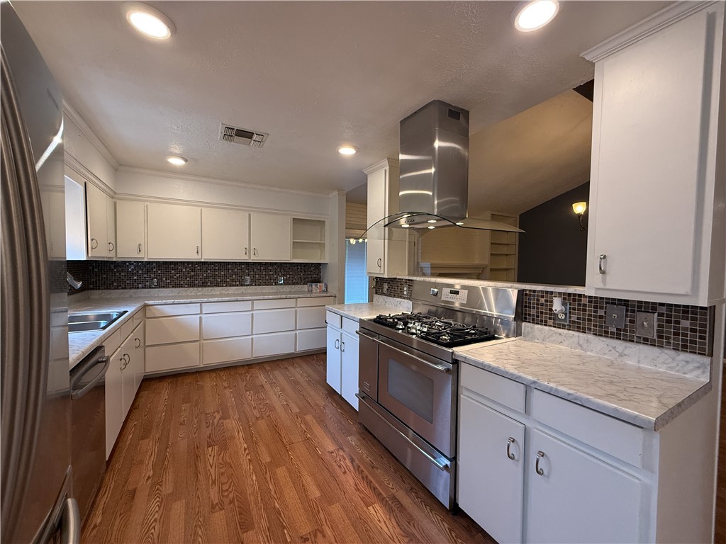 10502 Hemlock Road Corpus Christi, TX 78410 - Photo 9 of 31 a kitchen with a sink stove top oven and cabinets