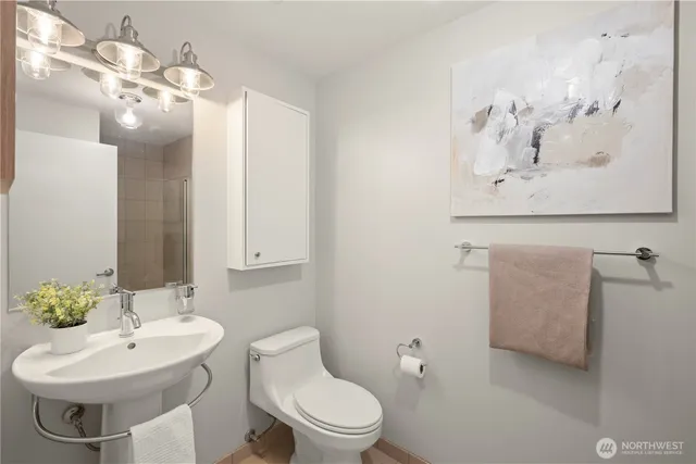 a bathroom with a toilet sink and mirror