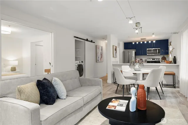 a living room with furniture and a chandelier