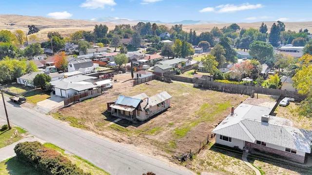 a view of a house with a yard and sitting area