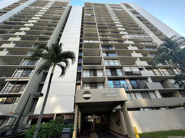 a kitchen with white cabinets and wooden floor