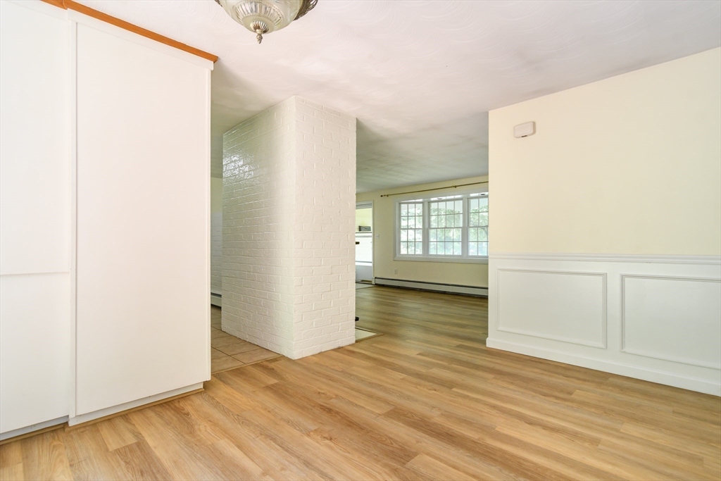 33 Eisenhower Road Framingham, MA 01701 - Photo 8 of 20 a view of an empty room with wooden floor