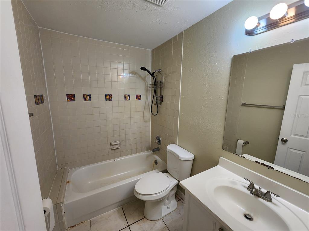249 Flamingo Road Oak Hill, FL 32759 - Photo 11 of 11 a bathroom with a sink toilet and shower