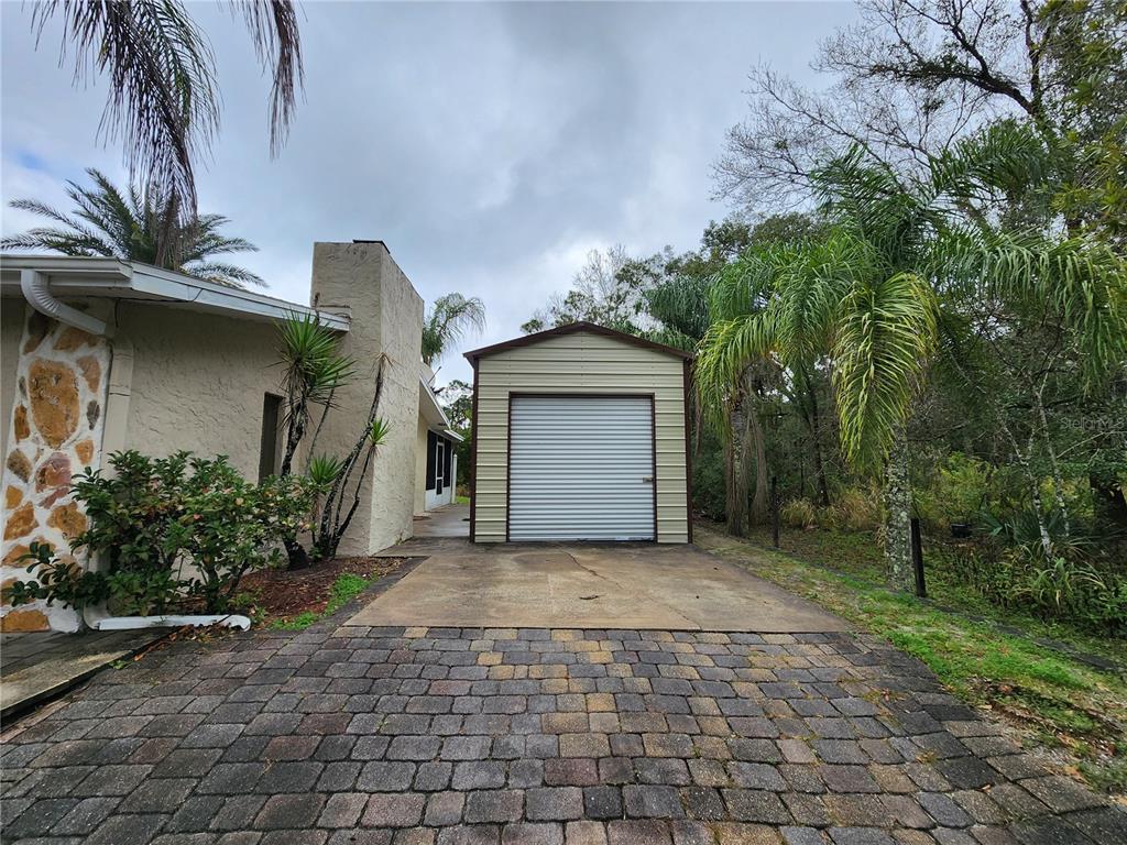 249 Flamingo Road Oak Hill, FL 32759 - Photo 2 of 11 a view of a house with a plants and trees