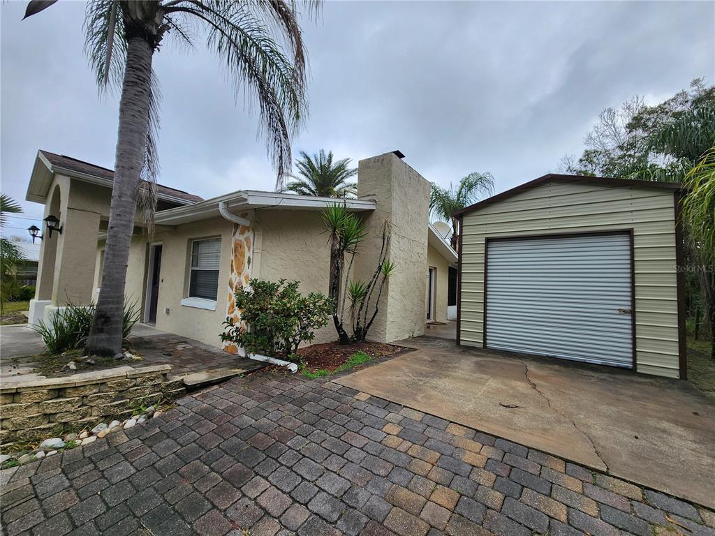 249 Flamingo Road Oak Hill, FL 32759 - Photo 3 of 11 a front view of a house with garden