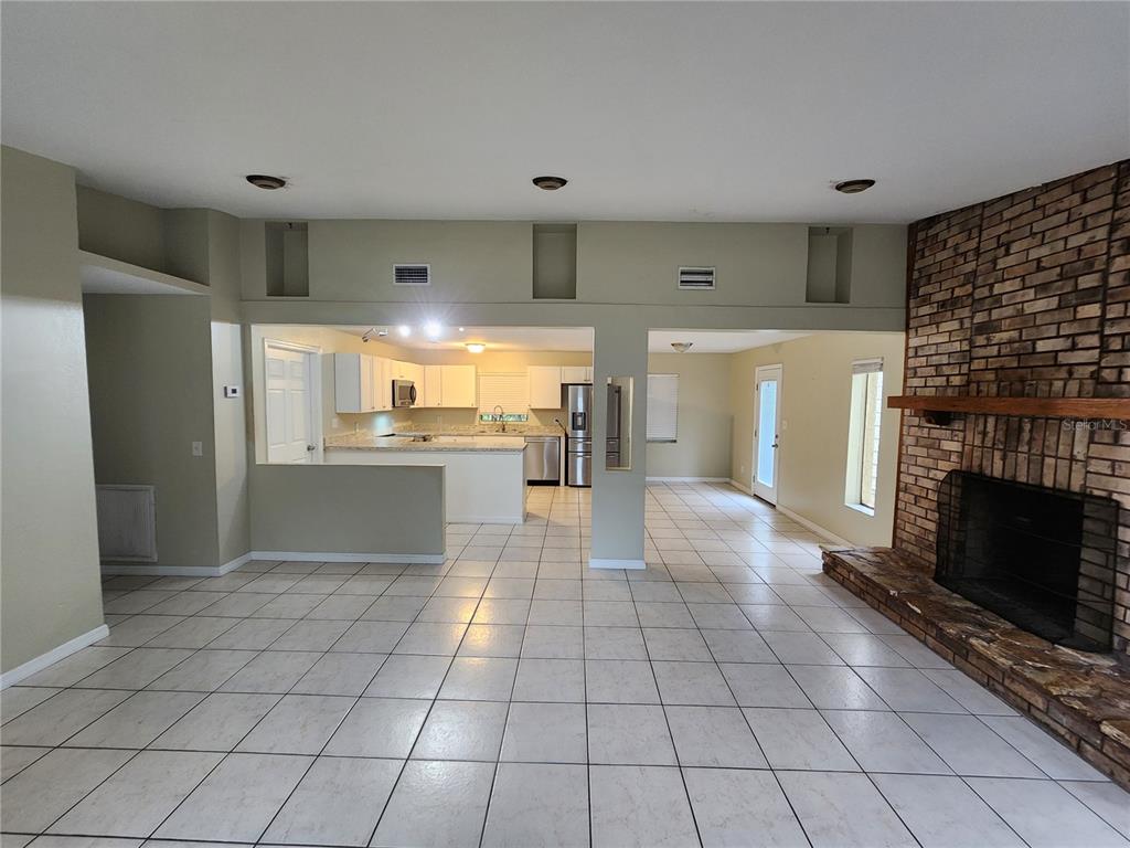 249 Flamingo Road Oak Hill, FL 32759 - Photo 5 of 11 a view of kitchen with granite countertop cabinets and refrigerator