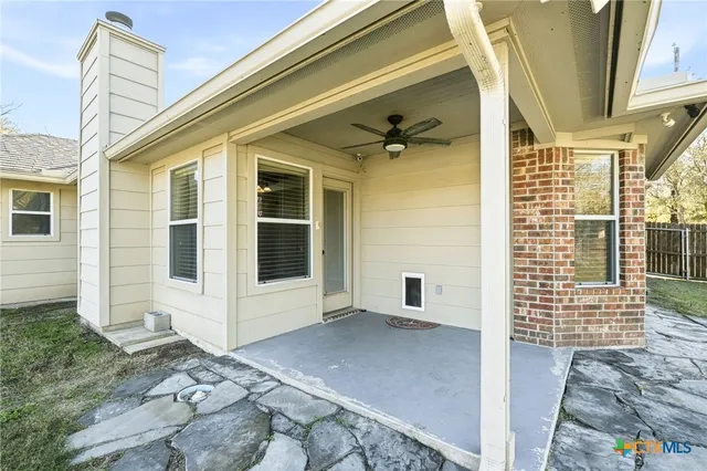 a view of a house with backyard and trees