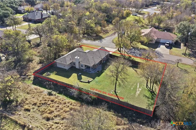 an aerial view of a houses with a yard