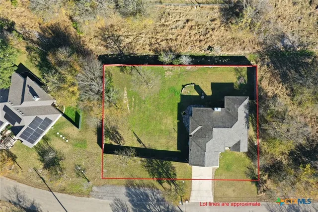 an aerial view of house with yard
