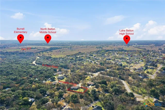 an aerial view of a house with a mountain