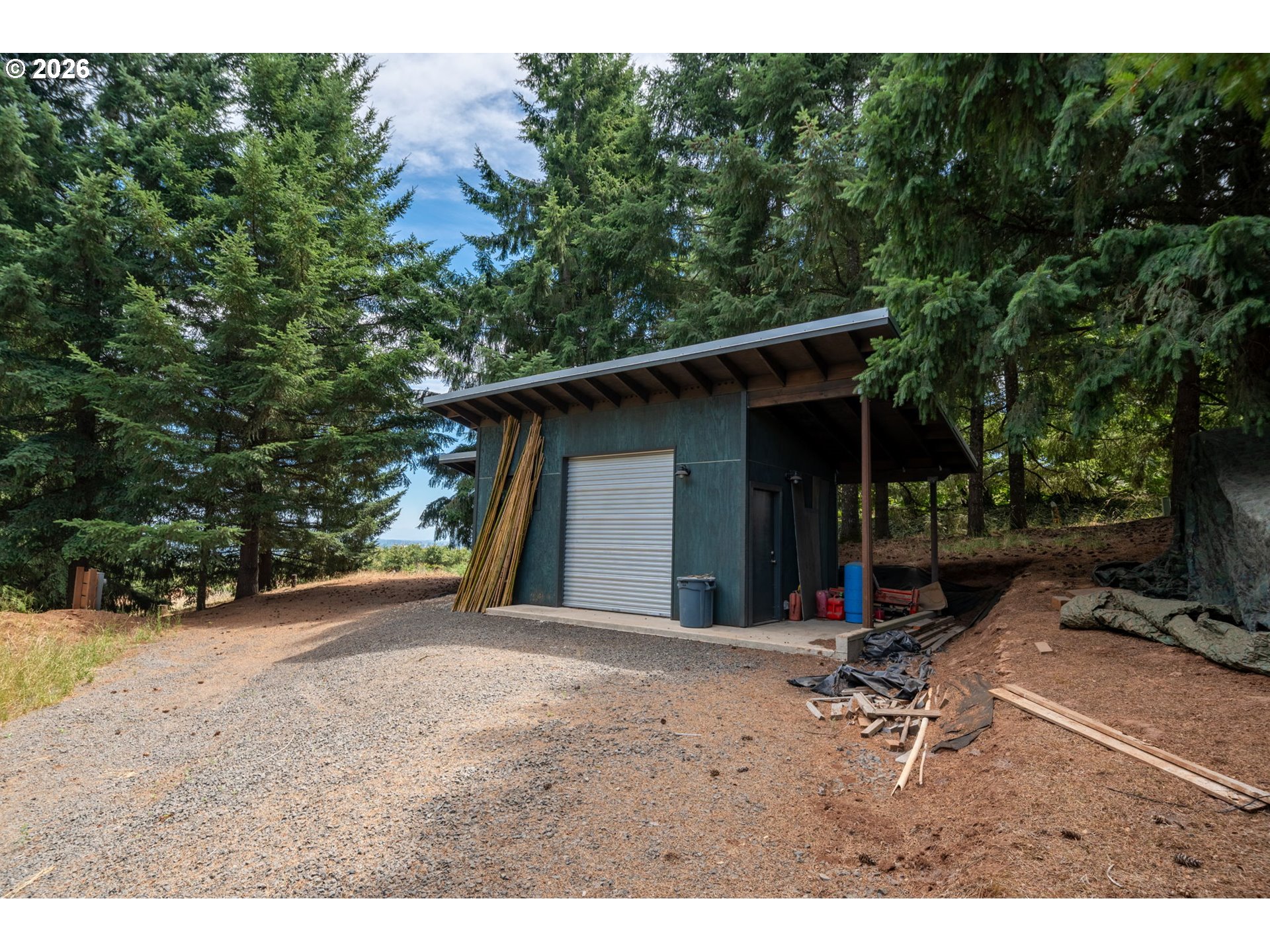 19601 Northeast Trunk Road Dundee, OR 97115 - Photo 8 of 16 a backyard of a house with table and chairs under an umbrella
