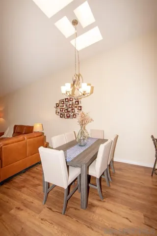 a view of a dining room with furniture wooden floor and chandelier