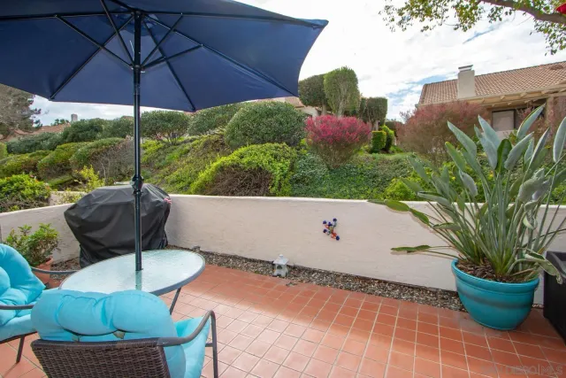 a view of a chairs and table in the balcony