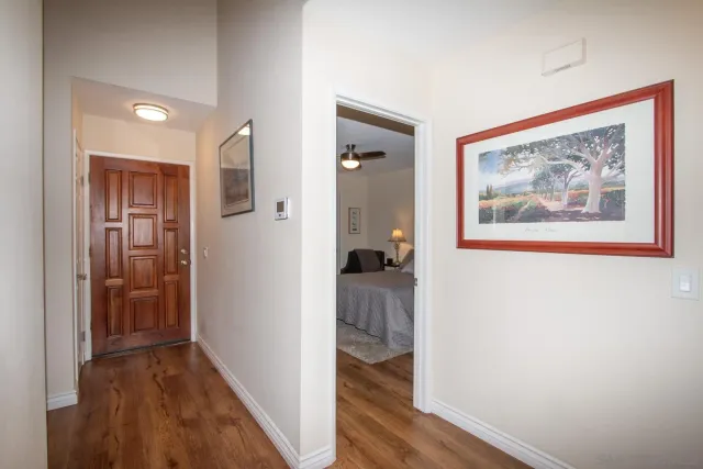 a view of a hallway with wooden floor