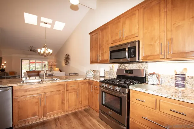 a kitchen with sink a microwave and cabinets