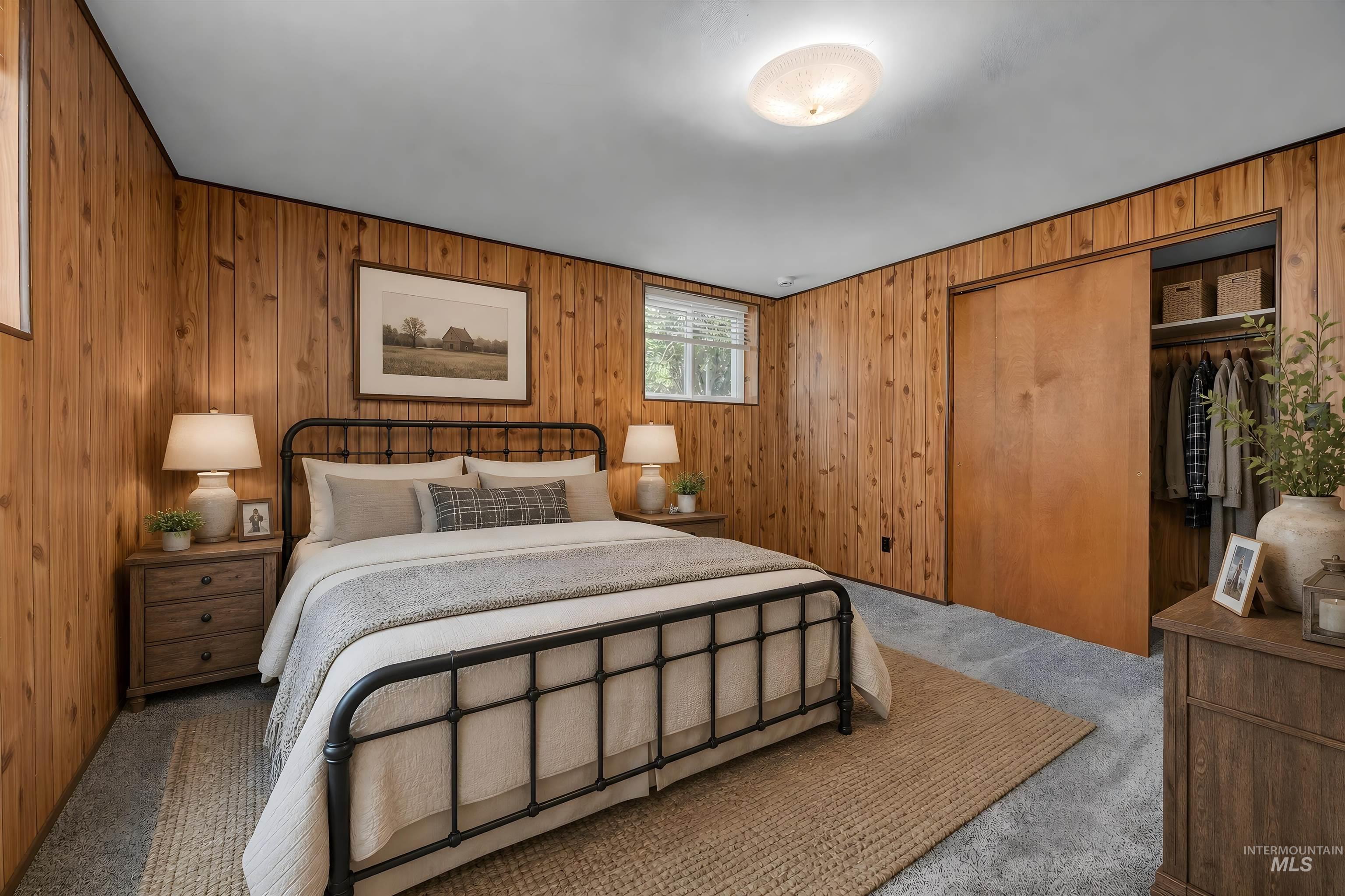 748 Pringle Road Weiser, ID 83672 - Photo 25 of 47 Wood-paneled room featuring light gray carpeting and a built-in closet with sliding wood doors