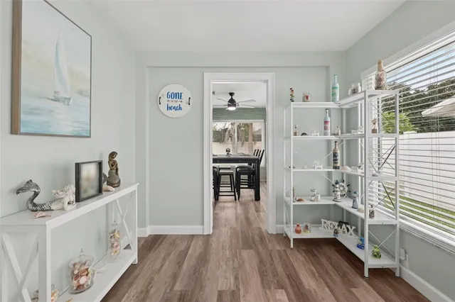 a kitchen with stainless steel appliances a table and chairs in it