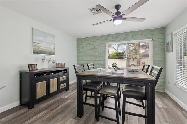 a kitchen with a stove a sink and a refrigerator with wooden floor