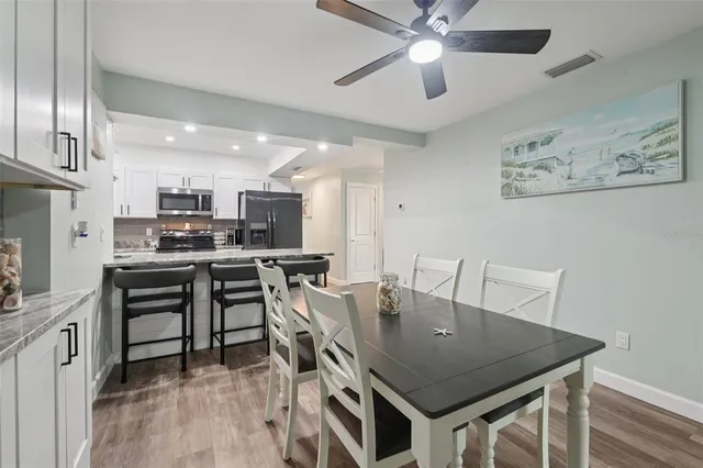 a kitchen with granite countertop cabinets a sink and appliances