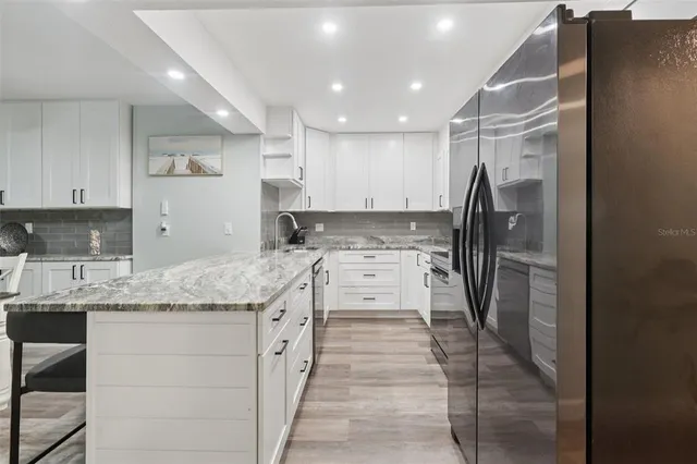 a view of a workspace with furniture and wooden floor