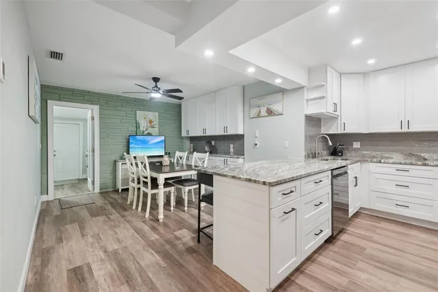 a view of a hallway with workspace and wooden floor
