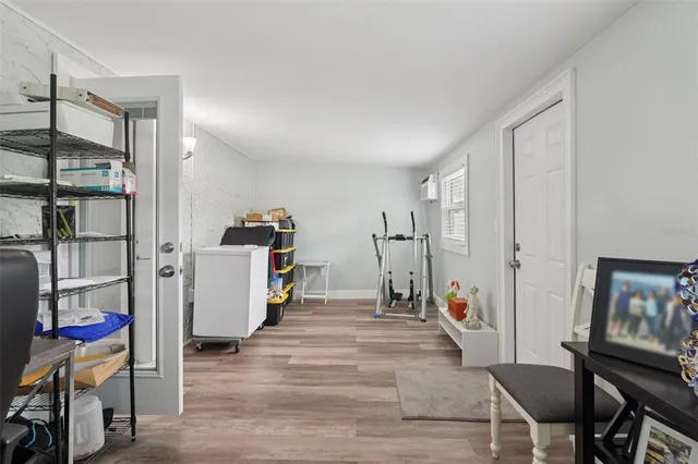 a view of a bedroom with baby crib and lounge chair