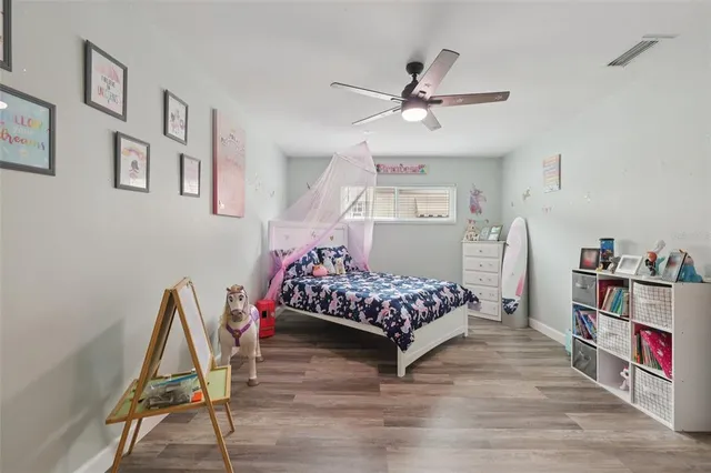 a bedroom with a bed window and a table