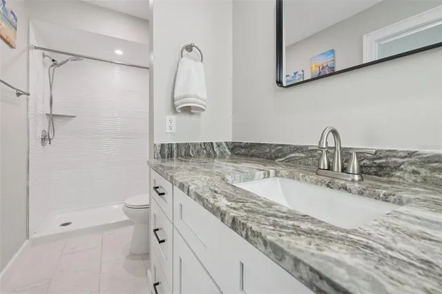 an aerial view of residential houses with outdoor space and swimming pool