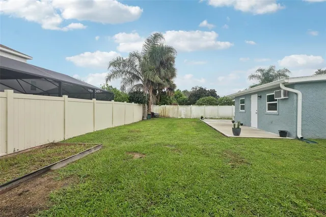 an aerial view of a house with outdoor space